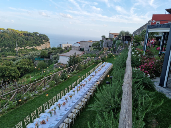 Imperial long table set among vineyards with Amalfi Coast view for an exclusive private dining experience