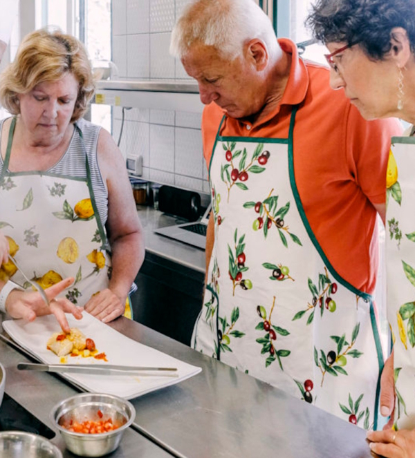 Participants learning how to prepare traditional Italian dishes during a cooking class