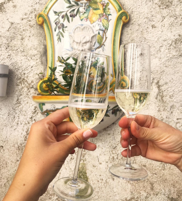 Couple toasting with wine glasses during a romantic dinner in an elegant setting