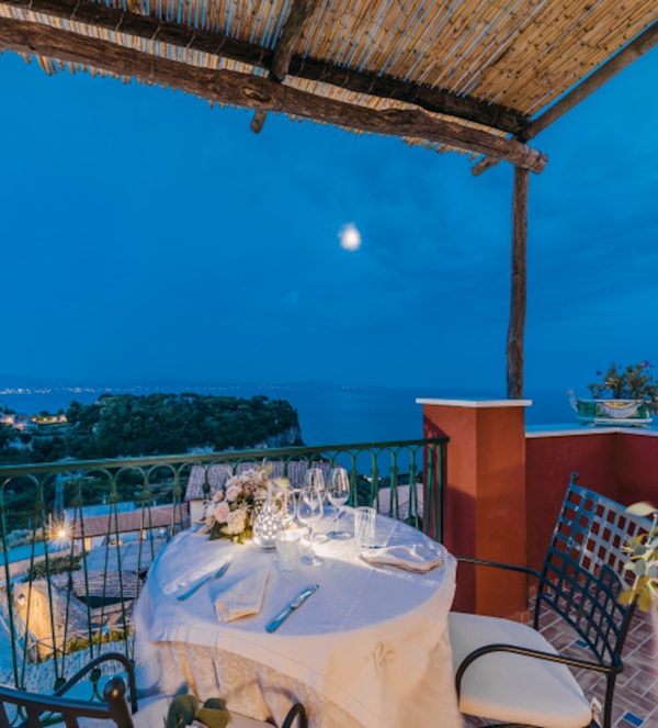 Romantic dinner on a private terrace with sea view over the Amalfi Coast at sunset